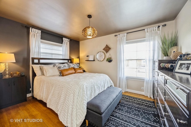bedroom featuring baseboards and wood finished floors