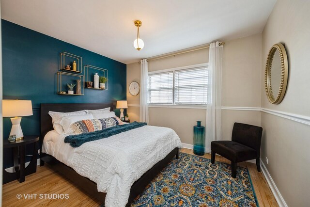 bedroom with wood finished floors and baseboards