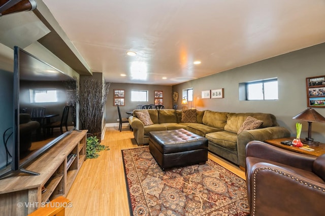 living room with plenty of natural light, light wood-style flooring, and recessed lighting