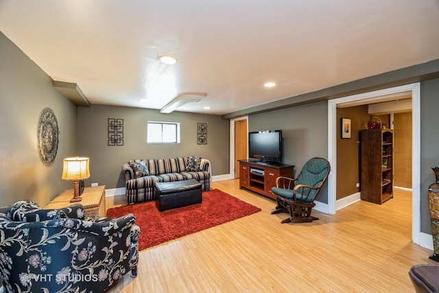 living room with baseboards, wood finished floors, and recessed lighting
