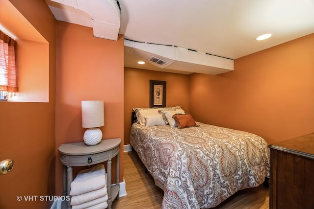bedroom with wood finished floors, visible vents, and recessed lighting