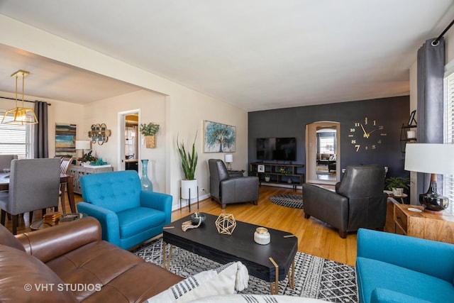 living area featuring baseboards and wood finished floors