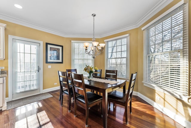 dining area with a wealth of natural light, a chandelier, baseboards, and dark wood-style floors