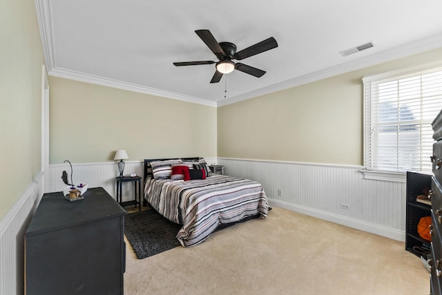 bedroom with carpet, visible vents, and crown molding