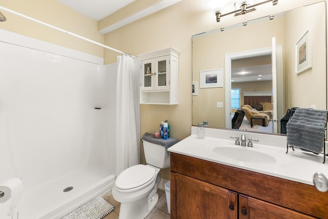 bathroom featuring tile patterned floors, vanity, a stall shower, and toilet