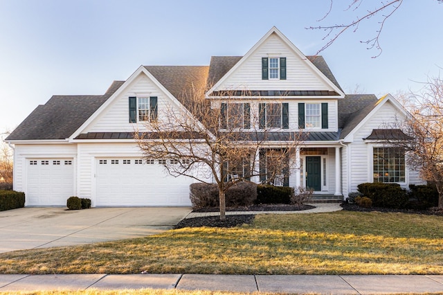 view of front of house featuring driveway, a front lawn, a standing seam roof, metal roof, and covered porch