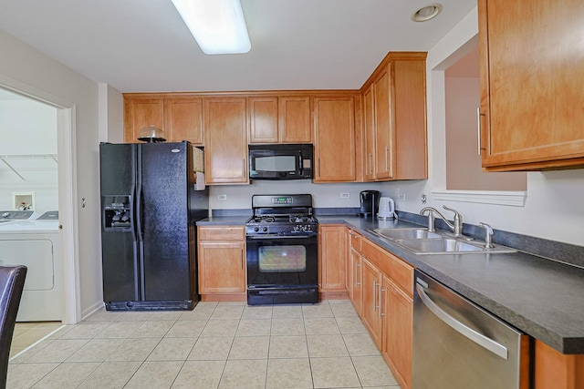 108 W Essington Dr Unit 108, Round Lake, IL 60073 - kitchen featuring dark countertops, washing machine and dryer, a sink, light tile patterned floors, and black appliances