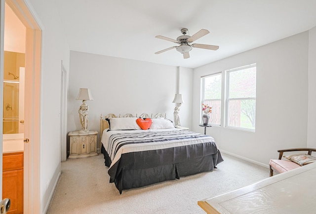 108 W Essington Dr Unit 108, Round Lake, IL 60073 - bedroom featuring baseboards, a ceiling fan, ensuite bath, and light carpet