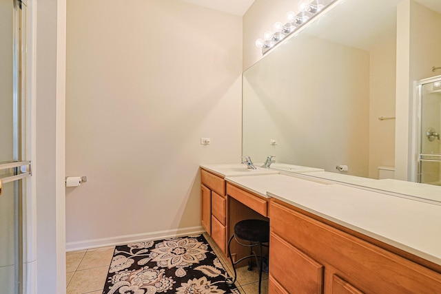 108 W Essington Dr Unit 108, Round Lake, IL 60073 - bathroom featuring vanity, toilet, tile patterned floors, baseboards, and a shower stall