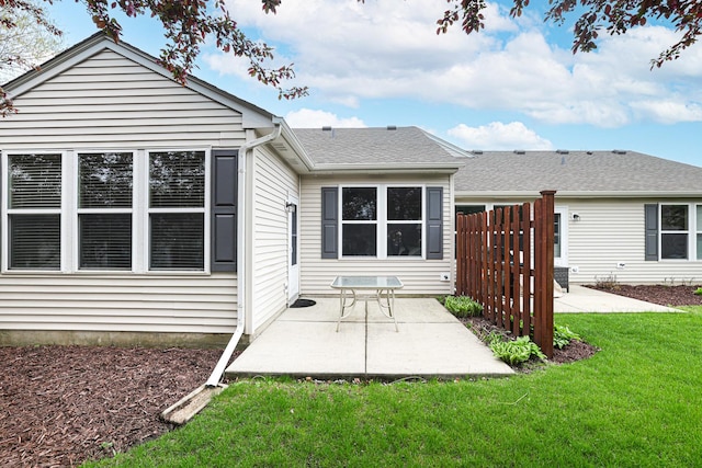 108 W Essington Dr Unit 108, Round Lake, IL 60073 - rear view of property featuring a yard, fence, a shingled roof, and a patio area