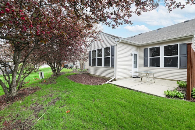 108 W Essington Dr Unit 108, Round Lake, IL 60073 - rear view of house with a lawn, roof with shingles, and a patio area