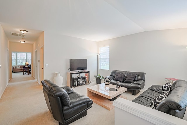 108 W Essington Dr Unit 108, Round Lake, IL 60073 - living room with visible vents, baseboards, vaulted ceiling, and light carpet