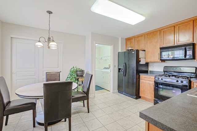 108 W Essington Dr Unit 108, Round Lake, IL 60073 - kitchen featuring washing machine and clothes dryer, dark countertops, light tile patterned floors, and black appliances