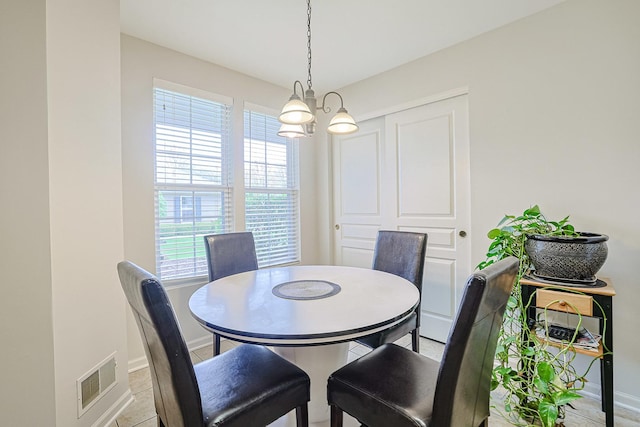 108 W Essington Dr Unit 108, Round Lake, IL 60073 - dining room featuring an inviting chandelier, baseboards, light tile patterned flooring, and visible vents