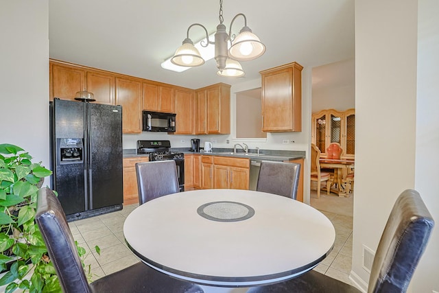 108 W Essington Dr Unit 108, Round Lake, IL 60073 - kitchen with decorative light fixtures, light tile patterned floors, a sink, black appliances, and a chandelier