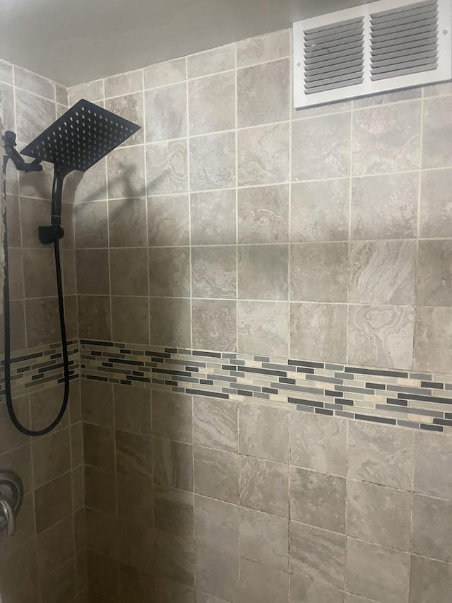 bathroom with tiled shower