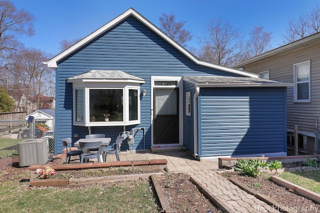 95 Hillside Ct, Fox Lake, IL 60020 - rear view of property with a garden, roof with shingles, fence, and central AC