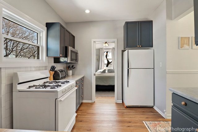 95 Hillside Ct, Fox Lake, IL 60020 - kitchen featuring baseboards, white appliances, light countertops, a ceiling fan, and light wood-style floors