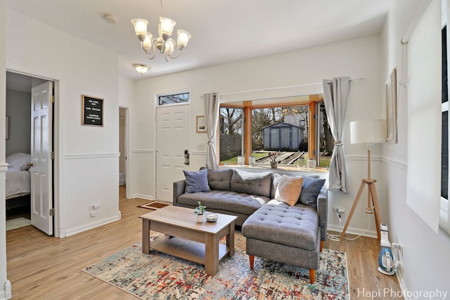 95 Hillside Ct, Fox Lake, IL 60020 - living room featuring a chandelier, light wood-style floors, and baseboards