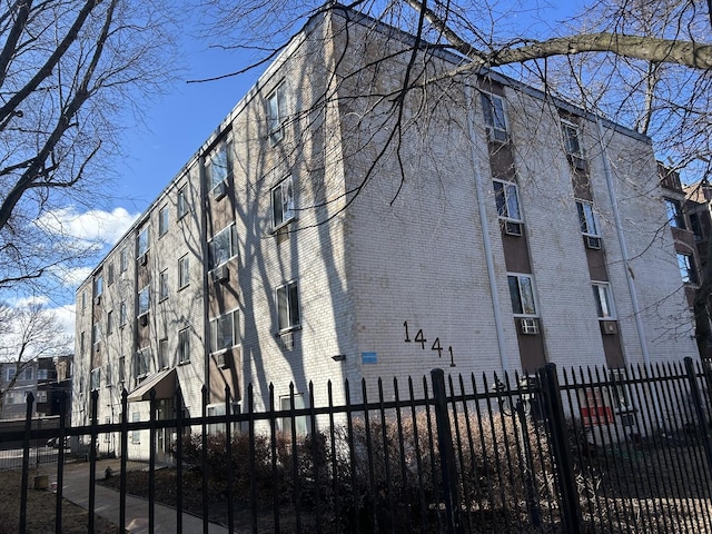 view of building exterior with fence