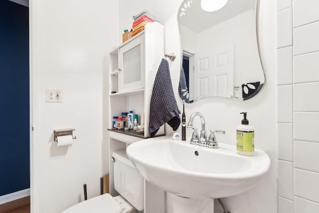 half bathroom with toilet and a sink