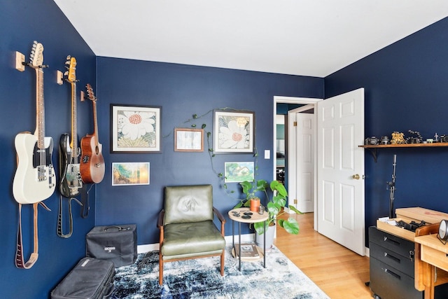 living area featuring baseboards and wood finished floors