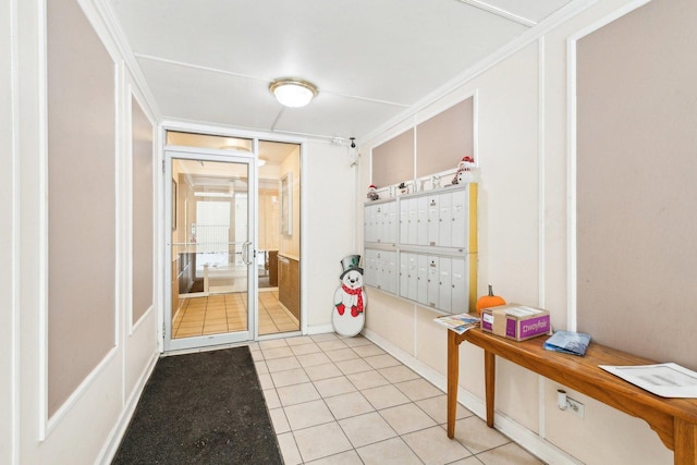 doorway with mail area and light tile patterned flooring