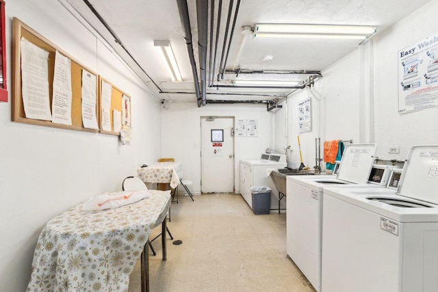 community laundry room with separate washer and dryer and light floors