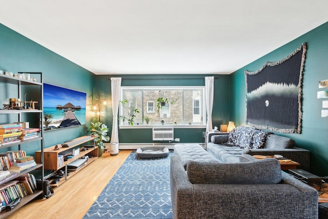 living room with wood finished floors and a wall mounted air conditioner
