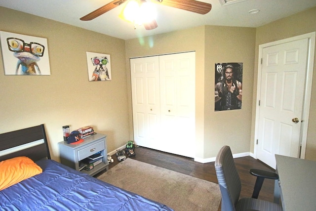 bedroom with baseboards, wood finished floors, a closet, and ceiling fan