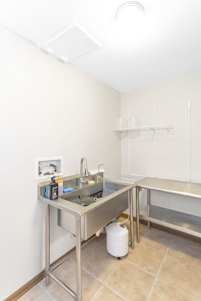 interior space with a sink and baseboards