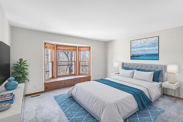 carpeted bedroom featuring visible vents and baseboards