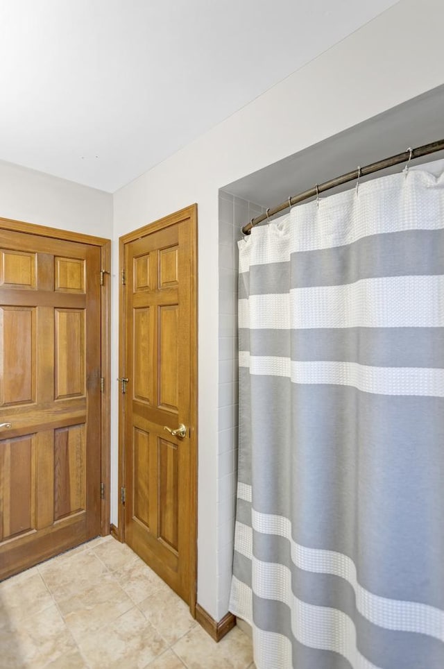 full bathroom featuring tile patterned floors and a shower with curtain