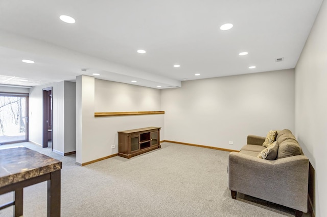 carpeted living room featuring baseboards, visible vents, and recessed lighting