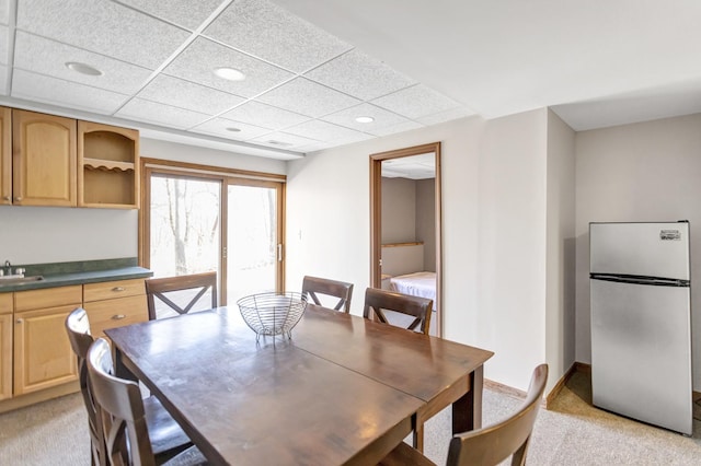 dining room with baseboards, recessed lighting, a paneled ceiling, and light carpet