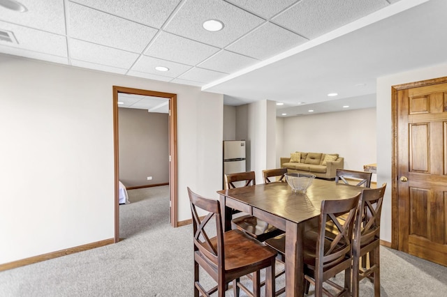 dining room featuring a paneled ceiling, baseboards, light carpet, recessed lighting, and visible vents