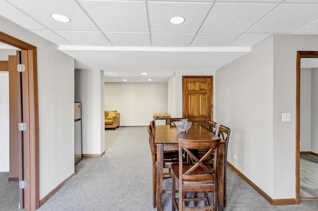 carpeted dining area featuring recessed lighting, baseboards, and a drop ceiling