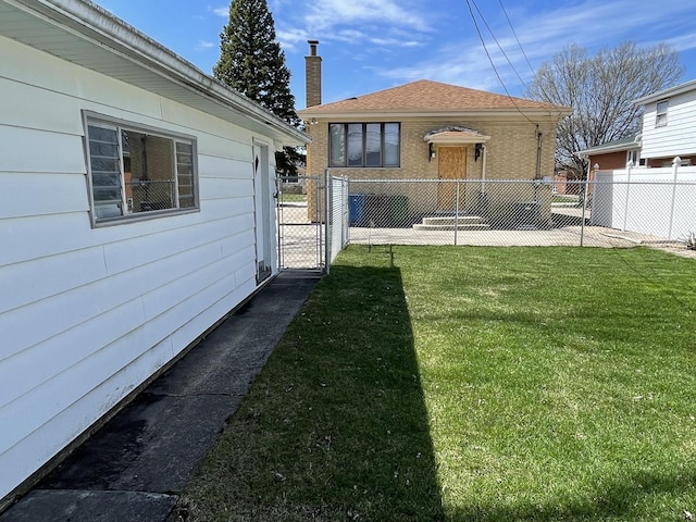 view of yard with fence and a gate