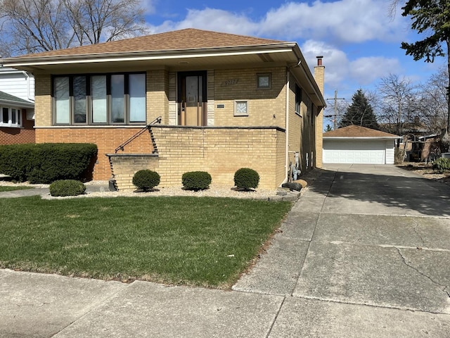 view of front of home featuring an outdoor structure, a front lawn, brick siding, a chimney, and a garage