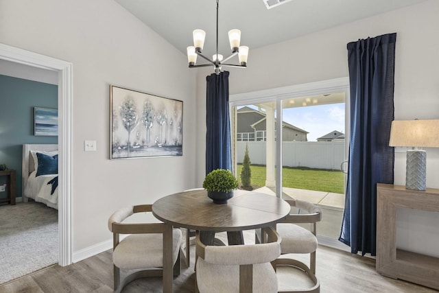 6367 Jasmine Ave, Portage, IN 46368 - dining area featuring visible vents, baseboards, wood finished floors, and an inviting chandelier