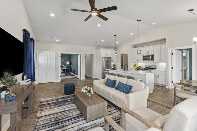 6367 Jasmine Ave, Portage, IN 46368 - living area with baseboards, recessed lighting, wood finished floors, ceiling fan, and high vaulted ceiling