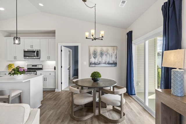 6367 Jasmine Ave, Portage, IN 46368 - dining space featuring lofted ceiling, light wood-style flooring, visible vents, and a chandelier
