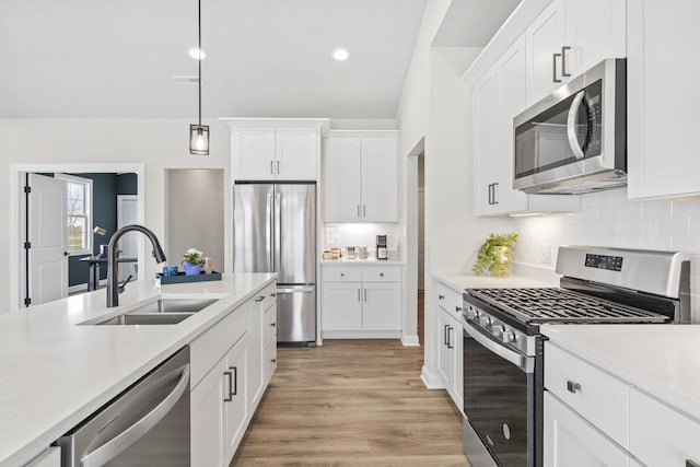 6367 Jasmine Ave, Portage, IN 46368 - kitchen with light countertops, white cabinetry, stainless steel appliances, and a sink