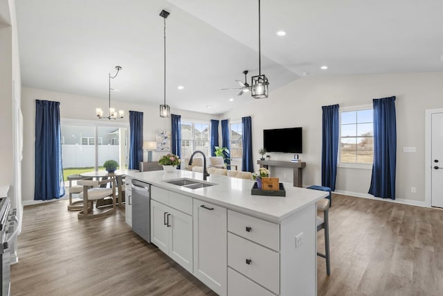 6367 Jasmine Ave, Portage, IN 46368 - kitchen featuring white cabinets, lofted ceiling, stainless steel appliances, a sink, and ceiling fan with notable chandelier