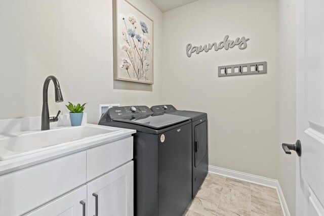 6367 Jasmine Ave, Portage, IN 46368 - washroom featuring washing machine and dryer, baseboards, cabinet space, and a sink