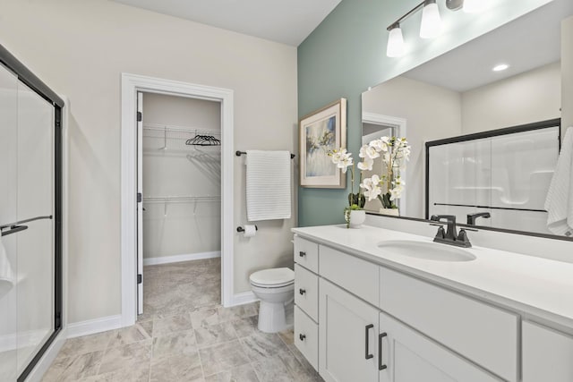 6367 Jasmine Ave, Portage, IN 46368 - bathroom featuring toilet, vanity, a walk in closet, and a stall shower