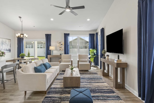 6367 Jasmine Ave, Portage, IN 46368 - living area featuring baseboards, recessed lighting, visible vents, ceiling fan with notable chandelier, and wood finished floors