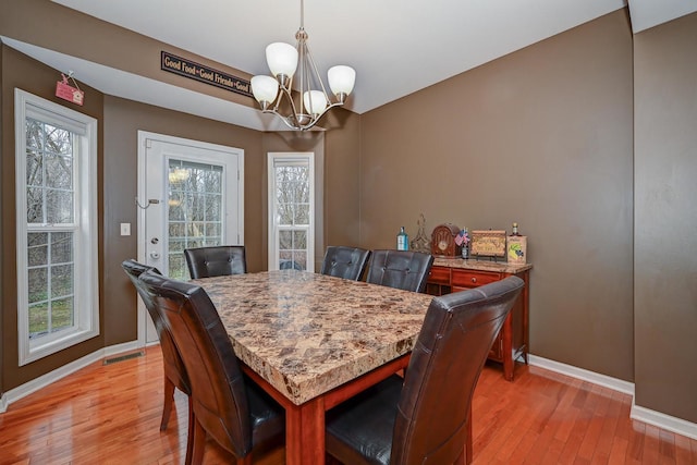 2136 Yale Cir, Hoffman Estates, IL 60192 - dining room with visible vents, baseboards, light wood-type flooring, and a chandelier