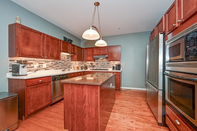 2136 Yale Cir, Hoffman Estates, IL 60192 - kitchen with light wood-type flooring, under cabinet range hood, a sink, stainless steel appliances, and backsplash
