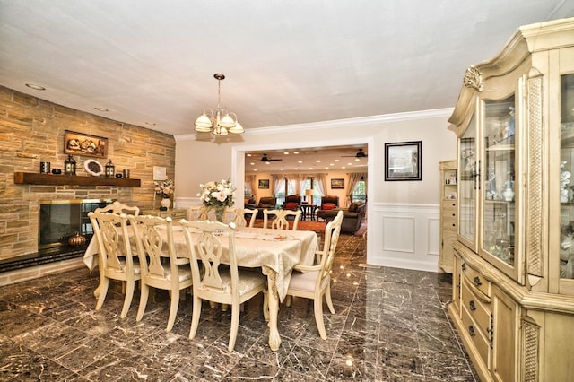 6776 N Laporte Ave, Lincolnwood, IL 60712 - dining space with ornamental molding, a chandelier, a wainscoted wall, a decorative wall, and a fireplace